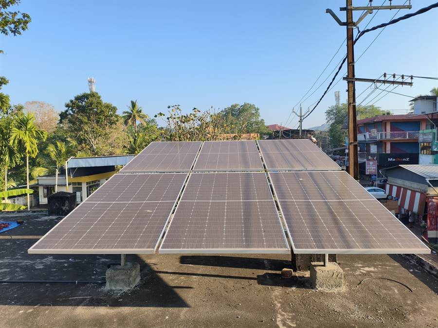A rooftop solar array on a flat concrete roof