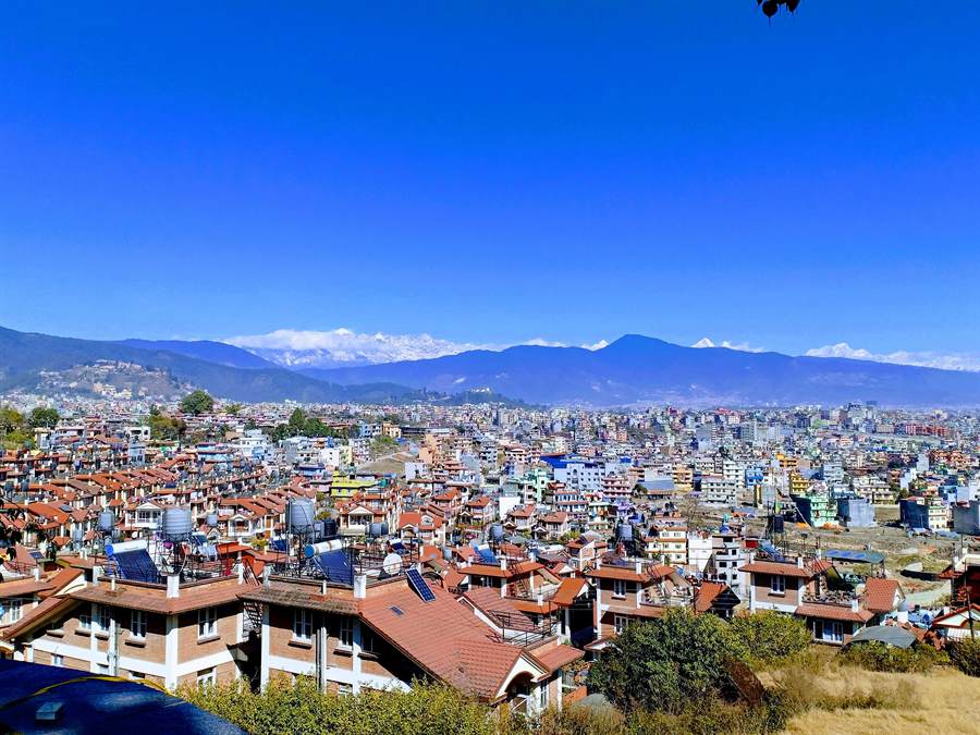Rooftops of the Kathmandu valley with hills behind